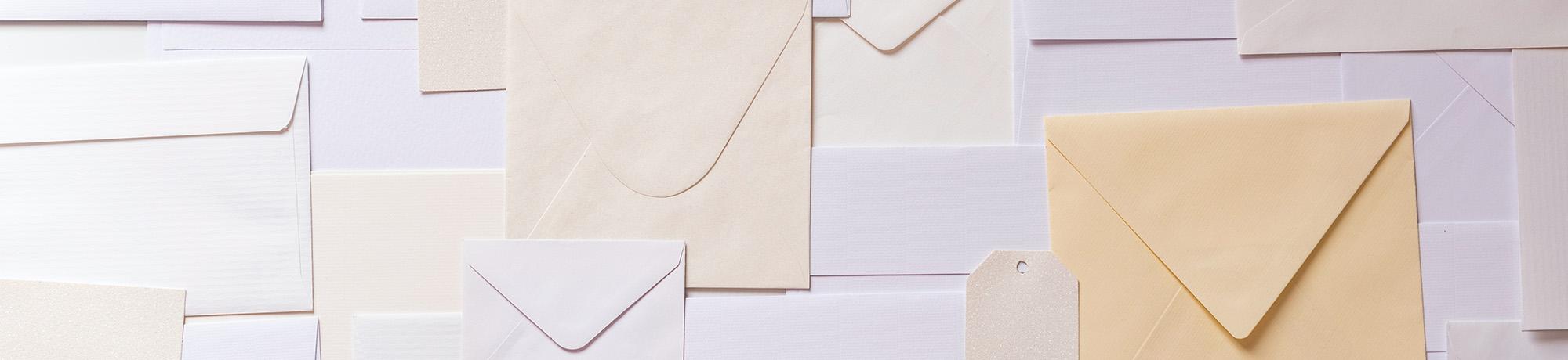 Envelopes of various sizes on a wall