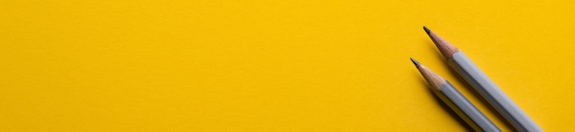 Pencils on yellow background
